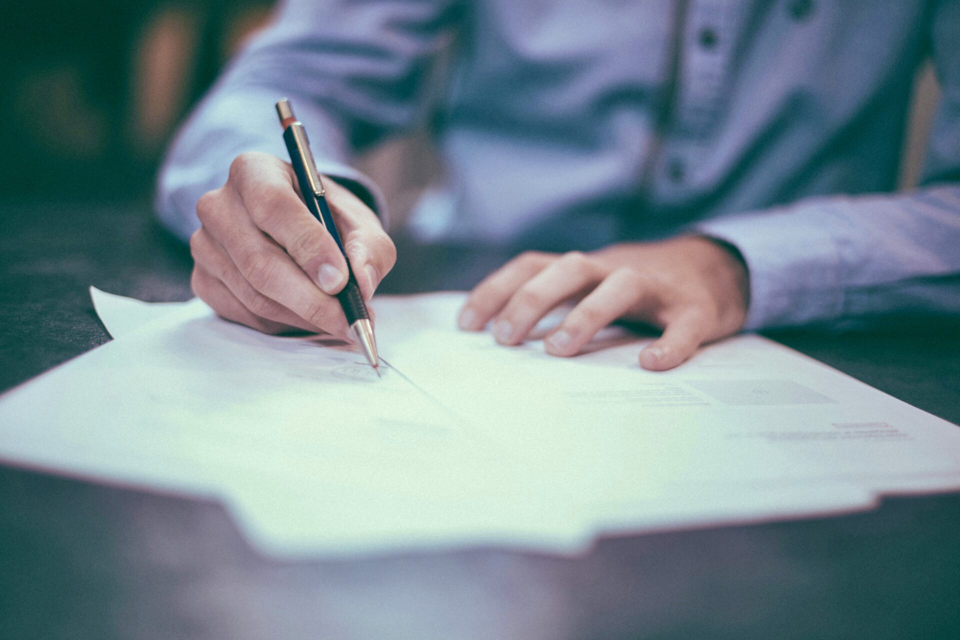 Man signing documents with pen