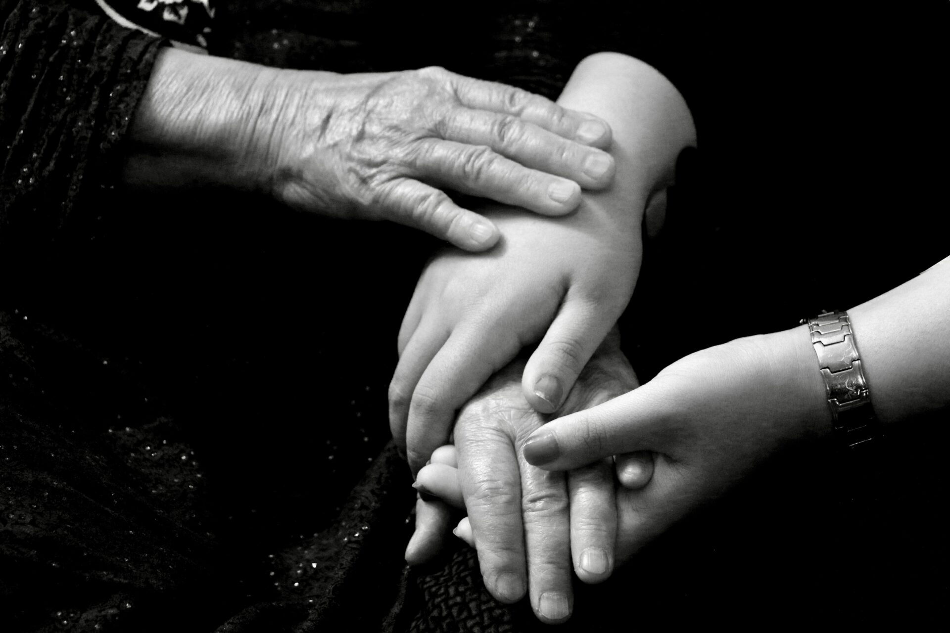 Family holding hands bw