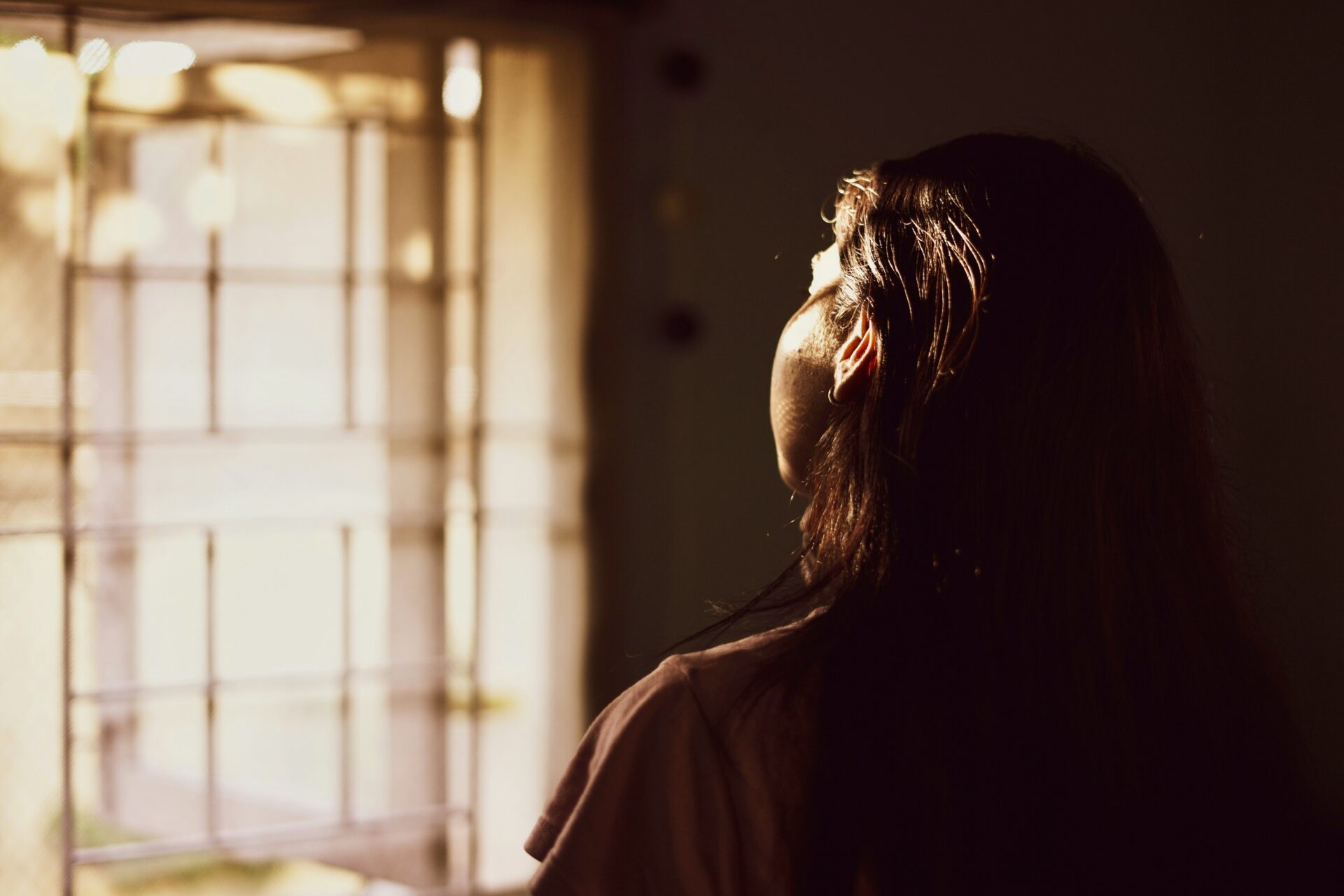 Person looking out of glowing window