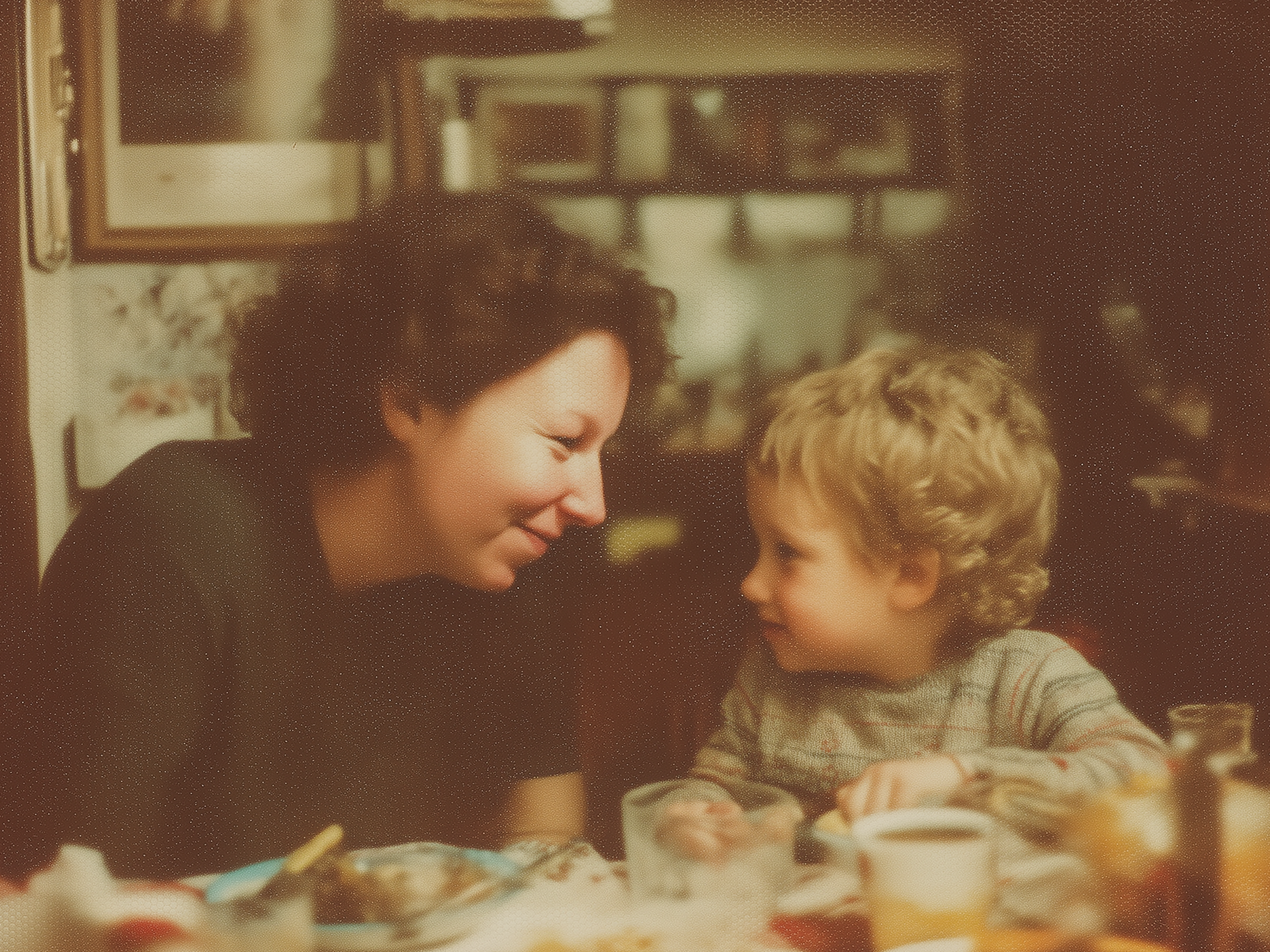 Nostalgic photo woman and child looking at eachother at dining table